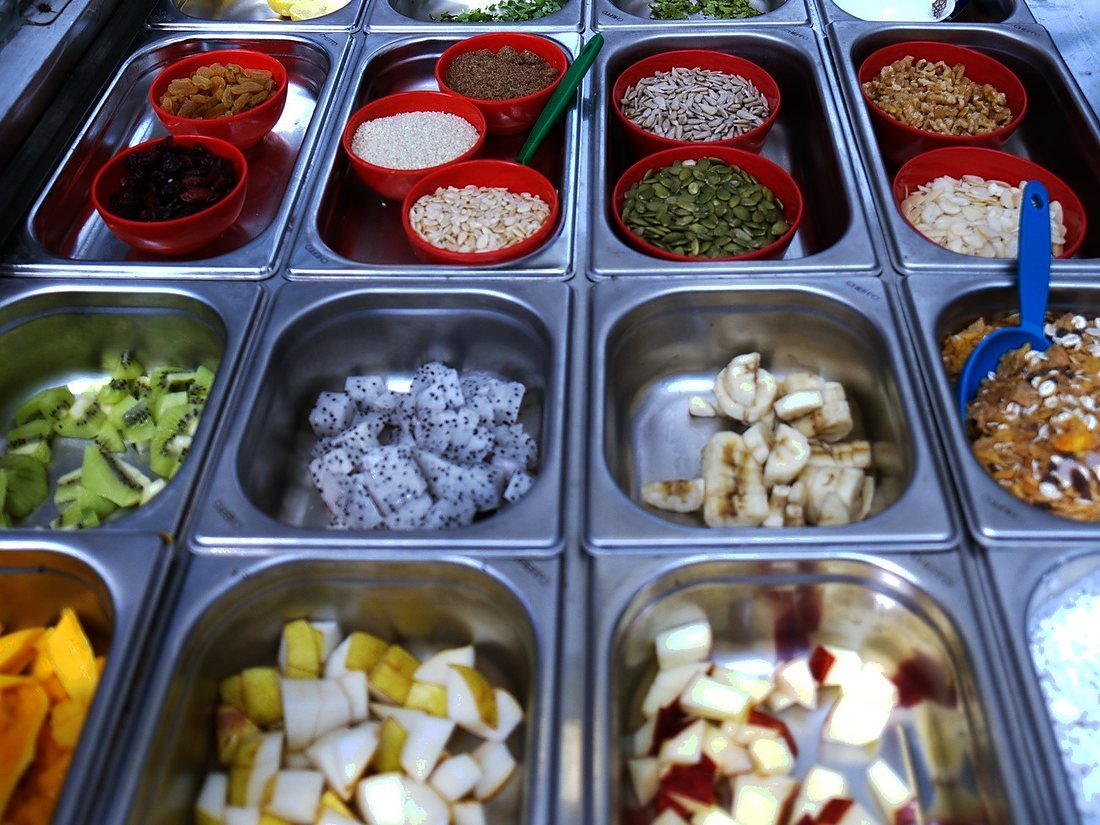 Fresh fruit, nuts and seeds prepped in trays on the Bowlsome® counter