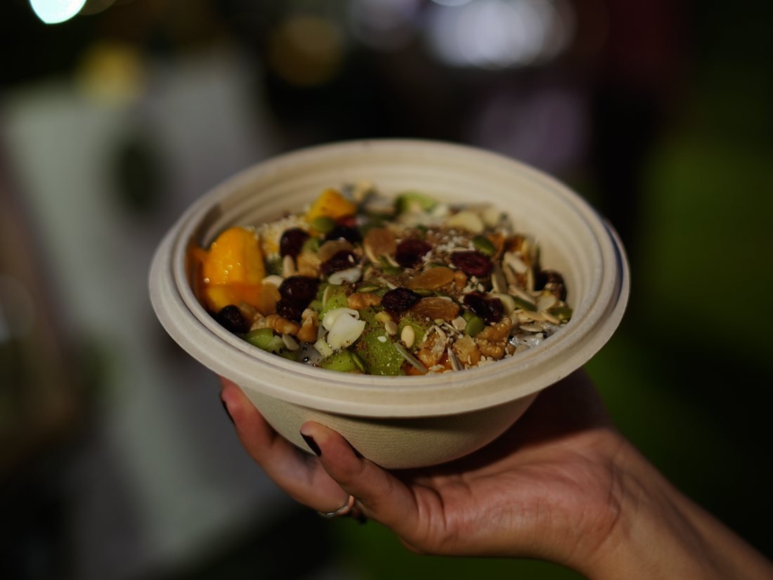 A guest holding a freshly built Bowlsome® bowl